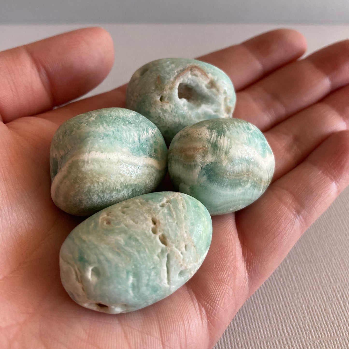 A handful of Blue Aragonite tumble stones